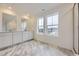 Bright bathroom with marble flooring, granite countertops, a double vanity, and plenty of natural light at 7321 Waterleaf Trl, Littleton, CO 80125