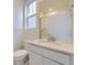 Clean, bright bathroom featuring a white sink and countertop and a large mirror at 7321 Waterleaf Trl, Littleton, CO 80125
