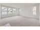 Spacious bedroom with neutral carpet, multiple large windows providing plenty of natural light at 7321 Waterleaf Trl, Littleton, CO 80125