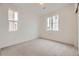 Bright bedroom with plush carpet, white walls, and two windows with neighborhood views at 7321 Waterleaf Trl, Littleton, CO 80125