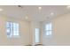 Bright bonus room with recessed lighting, vinyl flooring, and two windows with neighborhood views at 7321 Waterleaf Trl, Littleton, CO 80125