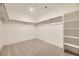 Bright walk-in closet featuring rods for hanging and built in shelving to maximize storage at 7321 Waterleaf Trl, Littleton, CO 80125