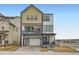 Modern three-story home with a two-car garage, second-floor balcony, and inviting curb appeal at 7321 Waterleaf Trl, Littleton, CO 80125