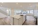 Open concept kitchen with a large island, stainless steel appliances and wood-style floors at 7321 Waterleaf Trl, Littleton, CO 80125