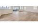 Bright living room with wood-style floors, a sliding glass door to balcony and multiple windows at 7321 Waterleaf Trl, Littleton, CO 80125