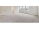 Bright main bedroom with neutral carpet and large windows, perfect for a peaceful retreat at 7321 Waterleaf Trl, Littleton, CO 80125