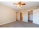 Neutral bedroom with a ceiling fan and ensuite bathroom plus a walk-in closet at 14300 Waterside Ln # L5, Broomfield, CO 80023