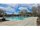 Large community pool on a sunny day, surrounded by pergolas and green trees at 14300 Waterside Ln # L5, Broomfield, CO 80023