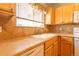 Well-lit kitchen showcasing tile backsplash, durable countertops, and a classic white sink at 14300 Waterside Ln # L5, Broomfield, CO 80023