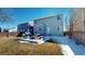 Fenced yard, patio with grill and picnic table, and lawn at 9649 Lansing Cir, Commerce City, CO 80022