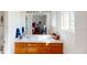 Bathroom featuring a double-sink vanity with generous lighting and a large mirror at 9649 Lansing Cir, Commerce City, CO 80022