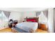 Cozy bedroom showcasing a wooden bed frame, natural lighting from the windows, and a closet at 9649 Lansing Cir, Commerce City, CO 80022