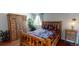 Bedroom showcasing a wooden bed frame, natural lighting from the windows, a closet and a plant at 9649 Lansing Cir, Commerce City, CO 80022