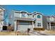 Two-story home with gray siding, attached two-car garage, and minimal front landscaping at 9649 Lansing Cir, Commerce City, CO 80022