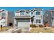 Two-story home with gray siding, attached two-car garage, and manicured front yard at 9649 Lansing Cir, Commerce City, CO 80022
