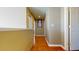 Bright hallway featuring hardwood floors, neutral paint, closet and doors that lead to the rest of the home at 9649 Lansing Cir, Commerce City, CO 80022