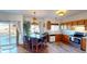 Eat-in kitchen featuring stainless steel appliances, light wood cabinets, and a sliding glass door to the exterior at 9649 Lansing Cir, Commerce City, CO 80022