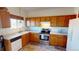 Kitchen with wood cabinets, stainless steel appliances, and light countertops at 9649 Lansing Cir, Commerce City, CO 80022