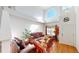 Spacious living room with high ceilings, arched window, and hardwood floors at 9649 Lansing Cir, Commerce City, CO 80022