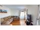 Open-concept living room boasts hardwood floors, large windows, and a comfortable sofa, perfect for relaxing at 9649 Lansing Cir, Commerce City, CO 80022