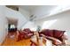 Living room with hardwood floors, staircase, and leather furniture at 9649 Lansing Cir, Commerce City, CO 80022