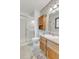 Bright bathroom with shower, a cabinet above the toilet, and a sink with vanity and counter at 7284 Dry Creek Rd, Niwot, CO 80503