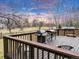 Wooden deck with outdoor grill and seating area overlooking the spacious backyard at 7284 Dry Creek Rd, Niwot, CO 80503