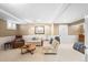 Finished basement with comfortable seating, carpeting, neutral paint, and ample space for recreation or relaxation at 843 Adams St, Denver, CO 80206