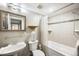 Classic bathroom featuring a vanity sink, mirrored medicine cabinet, toilet, and tiled shower-tub combination at 843 Adams St, Denver, CO 80206