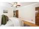 Bright bedroom with hardwood floors, fresh paint, a ceiling fan, and a glimpse into an adjacent sitting area at 843 Adams St, Denver, CO 80206