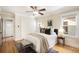 Cozy bedroom featuring a comfortable bed, hardwood floors, a ceiling fan, and natural light from the windows at 843 Adams St, Denver, CO 80206