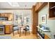 A cozy dining area features a small round table set near a window, complemented by stylish wooden cabinets and modern decor at 843 Adams St, Denver, CO 80206