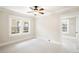 Bright empty room with fresh white trim, two large windows, neutral paint, and carpet flooring at 843 Adams St, Denver, CO 80206