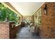 A cozy front porch includes wicker chairs, brick accents, and a pleasant view at 843 Adams St, Denver, CO 80206