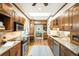 Bright kitchen features a central island, wood cabinets, granite countertops, and modern appliances for cooking and entertaining at 843 Adams St, Denver, CO 80206