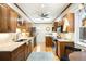 Traditional kitchen featuring wooden cabinets, granite countertops, stainless steel appliances, and a skylight for natural light at 843 Adams St, Denver, CO 80206