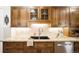 Close-up of a well-appointed kitchen featuring natural wood cabinetry, granite countertops, and stainless steel appliances at 843 Adams St, Denver, CO 80206