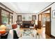 Bright living room boasts hardwood floors, a fireplace, and large windows with wood trim at 843 Adams St, Denver, CO 80206