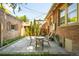 This patio has a table with four chairs, lush greenery, and a well-maintained lawn at 843 Adams St, Denver, CO 80206