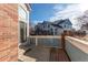 A view of the back patio of the home, with brick accents at 9576 Deerhorn Ct # 50, Parker, CO 80134