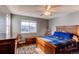 Cozy bedroom featuring wood furniture, a ceiling fan, and a view from the window at 9576 Deerhorn Ct # 50, Parker, CO 80134