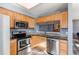 Modern kitchen with stainless steel appliances and wooden cabinetry at 9576 Deerhorn Ct # 50, Parker, CO 80134