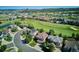 Aerial view of a neighborhood with golf course, trees, and a pond at 1328 Double Eagle Ct, Castle Rock, CO 80104