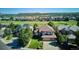 Aerial view of a well manicured suburban property near open spaces, golf course, and green hills at 1328 Double Eagle Ct, Castle Rock, CO 80104