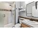 Updated bathroom with decorative tile accents, open shelving, and a glass enclosed shower at 1328 Double Eagle Ct, Castle Rock, CO 80104