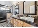 Bright bathroom with dual sinks, framed mirrors, stylish fixtures, and a glass-enclosed shower at 1328 Double Eagle Ct, Castle Rock, CO 80104