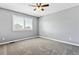 Clean, neutral bedroom with a large window and grey carpet at 1328 Double Eagle Ct, Castle Rock, CO 80104