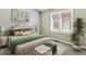 Comfortable bedroom with a queen-size bed, green accents, and plantation shutters at 1328 Double Eagle Ct, Castle Rock, CO 80104