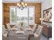 Well-lit dining room with wood paneled accent wall, a wooden table set for six, and modern chandelier lighting at 1328 Double Eagle Ct, Castle Rock, CO 80104