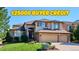 Charming two-story home with stone accents, three-car garage and well-maintained landscaping at 1328 Double Eagle Ct, Castle Rock, CO 80104